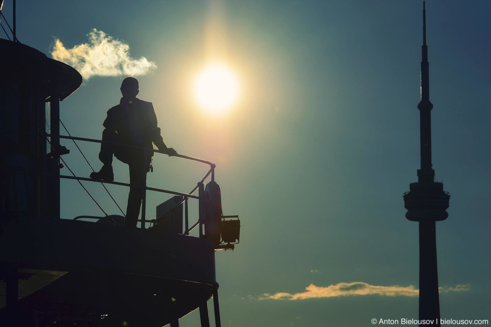 Toronto Island ferry captain silhouette with CN Tower 