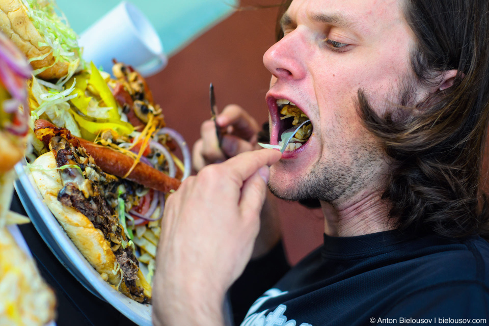 Yuriy Dybskiy participating in burger eating challenge at Riverbed Bistro in Keremos, BC