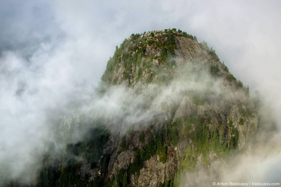 Seymour Mountain top view to remote peak in fog