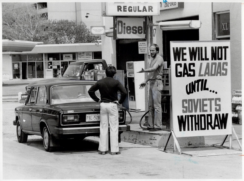 Courtesy of Toronto Public Library & the Toronto Star Archives. Photo credit Reg Innell -- Sign of the times: Star reporter Rick Brennan argues with gas station owner Neil Shepherd; who's refusing to gas Russian-made Lada cars -- 1980