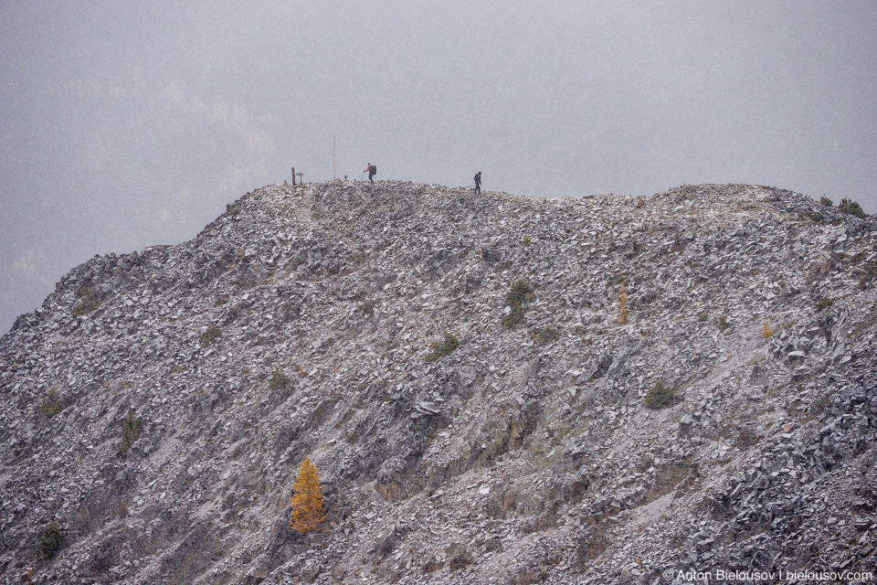 Hikers in snowfall at Frosty Mountain peak, BC